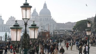 Tourists stroll in downtown Venice, Italy