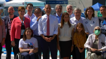 LA Mayor Eric Garcetti, IOC President Thomas Bach, and several Olympians and Paralympians gather for a group photo after announcing the dates for the 2028 LA Olympics.