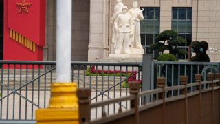 Chinese soldiers wearing masks guard the entrance to the military museum in Beijing