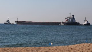 The Glory bulk carrier, center, makes its way from the port in Odesa, Ukraine