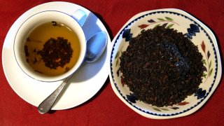 This photo shows a cup of black tea with a spoon and tea leaves pictured in London, Monday, Aug. 29, 2022.