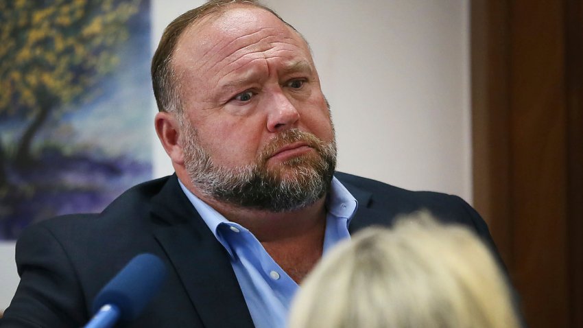 Conspiracy theorist Alex Jones attempts to answer questions about his emails asked by Mark Bankston, lawyer for Neil Heslin and Scarlett Lewis, during trial at the Travis County Courthouse in Austin, Wednesday Aug. 3, 2022. Jones testified Wednesday that he now understands it was irresponsible of him to declare the Sandy Hook Elementary School massacre a hoax and that he now believes it was “100% real.”