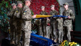 Servicemen pay last respect at the coffin of Olga Simonova