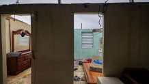 Nelson Cirino's home stands with its roof torn off by the winds of Hurricane Fiona in Loiza, Puerto Rico, Sunday, Sept. 18, 2022.(AP Photo/Alejandro Granadillo)