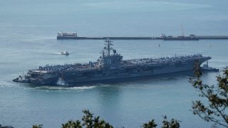 U.S. aircraft carrier USS Ronald Reagan is escorted into port in Busan, South Korea