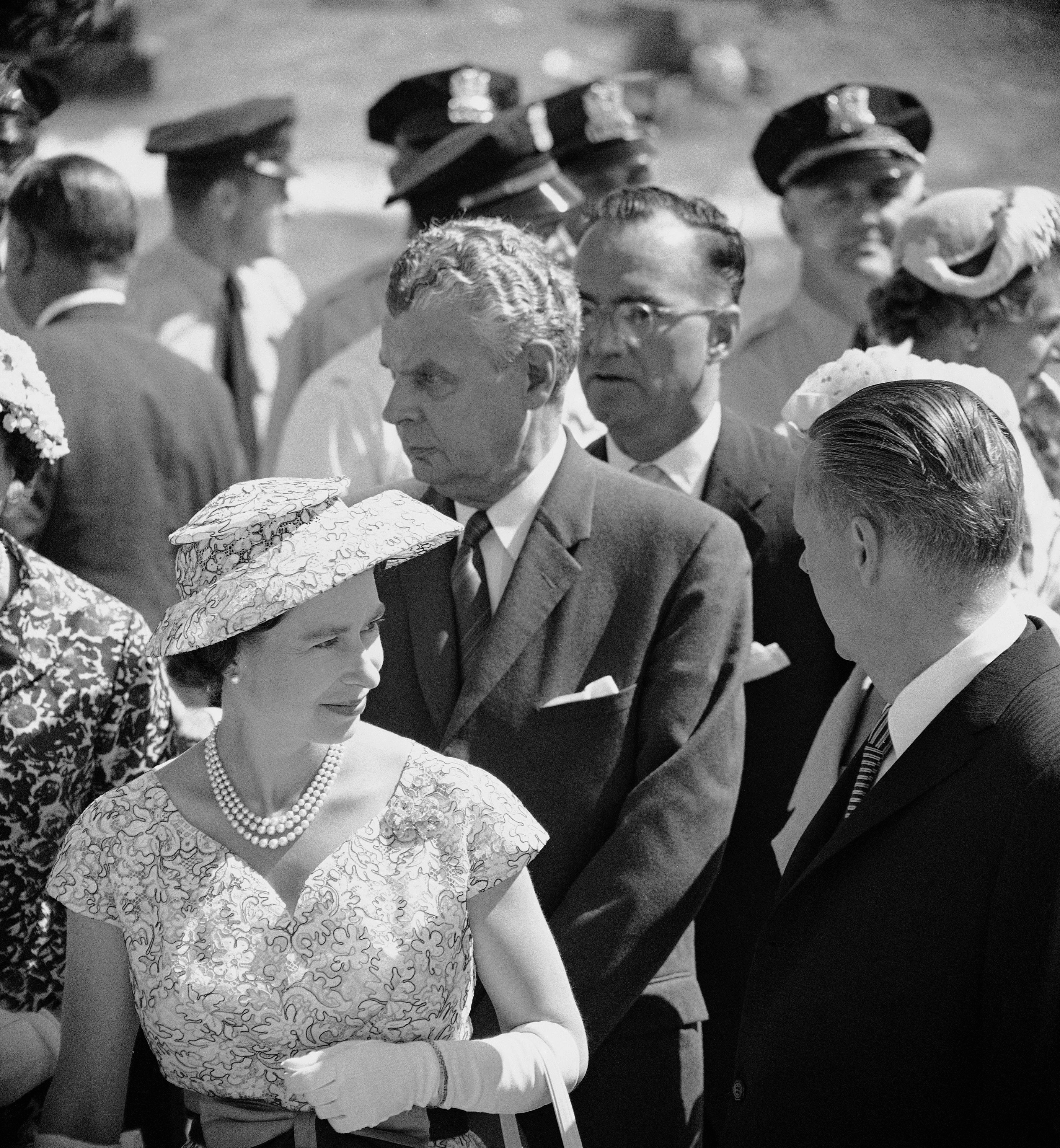 Queen Elizabeth II, monarch of Britain, attired for a summery day, stands with Gov. William G. Stratton, right, as she arrives in Chicago for a tour of the city, July 6, 1959.  (AP Photo/J. Walter Green)