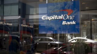 Signage is displayed inside the window of a Capital One Financial Corp. bank branch