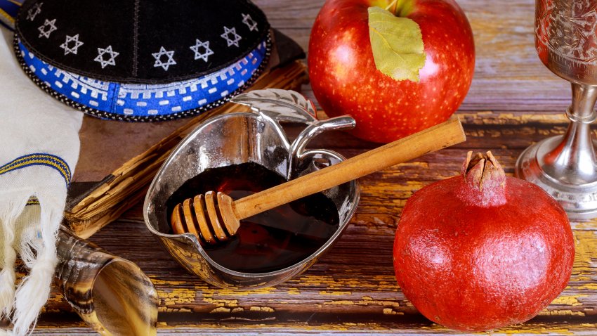 Shofar and tallit with glass honey jar and fresh ripe apples. Jewesh new year symbols