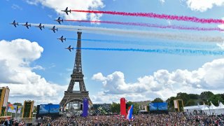 rench Elite acrobatic team Patrouille de France flyes over the Eiffel Tower during the Olympic Games handover ceremony on August 08, 2021 in Paris, France.