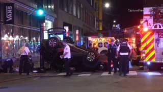 A car flipped onto its roof is seen in Chicago's Loop after it was struck by a tow truck.