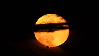 NEW YORK, NY – OCTOBER 20: Full moon also known as “Hunter’s Moon” rises behind the Brooklyn Bridge in New York City, as seen from Jersey City of New Jersey in United States on October 21, 2021. (Photo by Tayfun Coskun/Anadolu Agency via Getty Images)