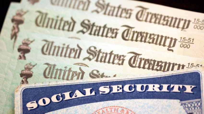 WASHINGTON, DC – OCTOBER 14: In this photo illustration, a Social Security card sits alongside checks from the U.S. Treasury on October 14, 2021 in Washington, DC. The Social Security Administration announced recipients will receive an annual cost of living adjustment of 5.9%, the largest increase since 1982. The larger increase is aimed at helping to offset rising inflation. (Photo illustration by Kevin Dietsch/Getty Images)