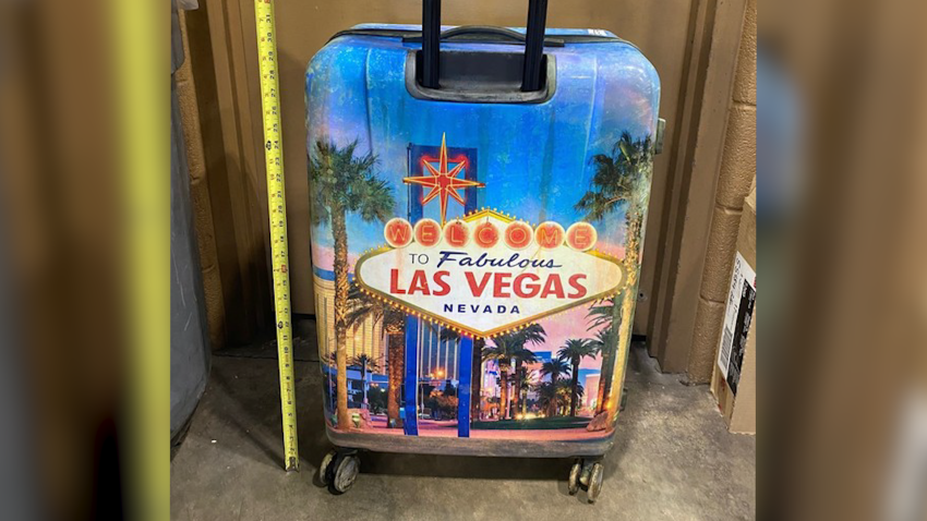 Police photo of Las Vegas suitcase with measuring tape next to it