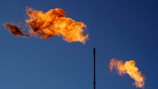 FILE - Flares burn off methane and other hydrocarbons