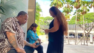 Chico Kaonohi, left, prays with Priscilla Hoʻopiʻi, center, and Lana Vierra, right, outside U.S. District Court in Honolulu, Thursday, Nov. 17, 2022, after his Native Hawaiian son was found guilty of a hate crime in the 2014 beating of a white man.