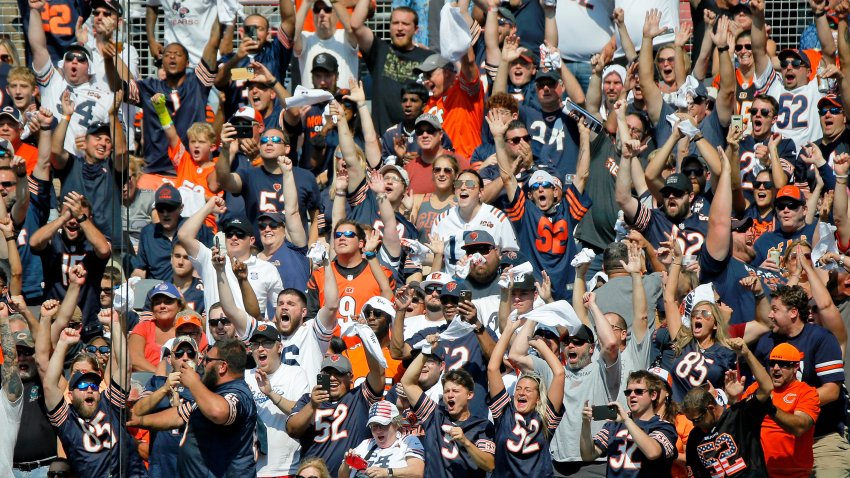 Sep 19, 2021; Chicago, Illinois, USA; Chicago Bears fans celebrate a touchdown against the Cincinnati Bengals during the first quarter at Soldier Field. Mandatory Credit: Jon Durr-USA TODAY Sports
