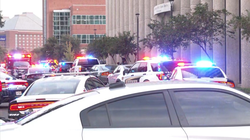 Law enforcement surround the Dallas County Medical Examiner building and neighboring Dallas County Health and Human Services building.