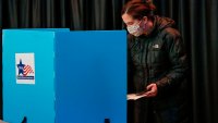 A woman casts her ballot at the United Center on Election Day in Chicago, Illinois, on November 3, 2020. – Americans were voting on Tuesday under the shadow of a surging coronavirus pandemic to decide whether to reelect Republican Donald Trump, one of the most polarizing presidents in US history, or send Democrat Joe Biden to the White House. (Photo by KAMIL KRZACZYNSKI / AFP) (Photo by KAMIL KRZACZYNSKI/AFP via Getty Images)