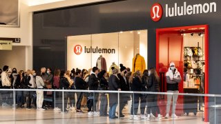 People line up to enter a store during Black Friday shopping at Fashion Outlets of Chicago in Rosemont of Greater Chicago Area, Illinois, the United States, on Nov. 26, 2021.