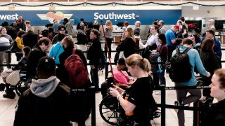 Travelers at Baltimore Washington International airport deal with the impact of Southwest Airlines canceling more than 12,000 flights around the Christmas holiday weekend across the country and in Baltimore, Maryland, December 27, 2022.