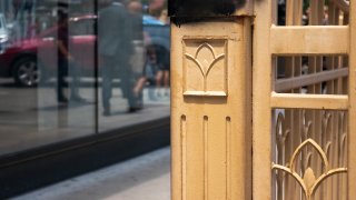 Design on gate around stairwell leading to Lower Wacker depicting the Y municipal device which represents the 3 branches of the Chicago River.