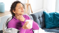 Portrait of black woman suffering sore throat at home