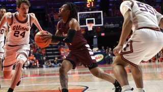 CHAMPAIGN, IL – DECEMBER 17: Messiah Thompson (1) guard Alabama A&M University Bulldogs splits defenders Matthew Mayer (24) guard/forward and Skyy Clark (55) guard University of Illinois Fighting Illini during a non-conference basketball game against the University of Illinois Fighting Illini, Saturday, December 17, 2022, at State Farm Center in Champaign, Illinois. (Photo by David Allio/Icon Sportswire via Getty Images)