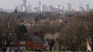 A man exercises in a park overlooking the city center of Birmingham, U.K., on Thursday, Jan. 28, 2021.