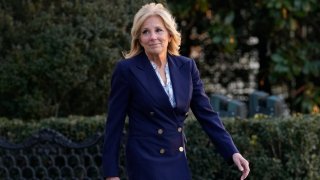 First Lady Jill Biden walks out of the White House in blue jacket