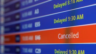A video board shows flight delays and cancellations at Ronald Reagan Washington National Airport in Arlington, Virginia, Jan. 11, 2023.