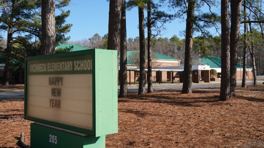 A school sign wishing students a “Happy New Year” is seen outside Richneck Elementary School on January 7, 2023 in Newport News, Virginia. (Photo by Jay Paul/Getty Images)