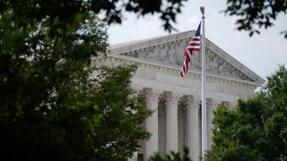 FILE - An American flag waves in front of the U.S. Supreme Court building in Washington, June 27, 2022.