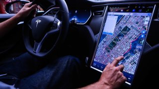 A driver uses the map navigation feature on a touchscreen control panel just prior to the Tesla Motors Inc. 8.0 software update inside a Model S P90D vehicle in New York, U.S., on Monday, Sept. 19, 2016.