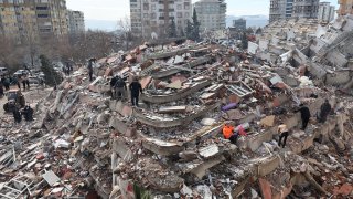 Civilians look for survivors under the rubble of collapsed buildings in Kahramanmaras, close to the quake’s epicentre, the day after a 7.8-magnitude earthquake struck the country’s southeast, on February 7, 2023.