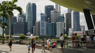 People gather outside the ArtScience Museum at Marina Bay Sands in Singapore on January 17, 2023. (Photo by Roslan RAHMAN / AFP) (Photo by ROSLAN RAHMAN/AFP via Getty Images)