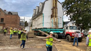 Workers prepare to move the original structure that held what is believed to be the oldest schoolhouse in the U.S. for Black children in Williamsburg, Virginia, on Friday, Feb. 10, 2023.