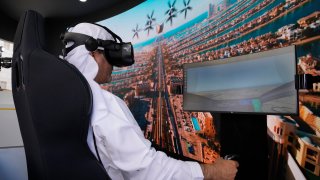 A man experiences a driving simulator of a flying tax
