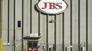 A worker heads into the JBS meatpacking plant in Greeley, Colo., on Oct. 12, 2020. Packers Sanitation Services Inc., or PSSI, one of the country's largest food safety cleaning service providers employed more than 100 children as young as 13 in dangerous jobs at 13 meat processing plants in eight states, including JBS, the U.S. Department of Labor said Friday, Feb. 17, 2023.