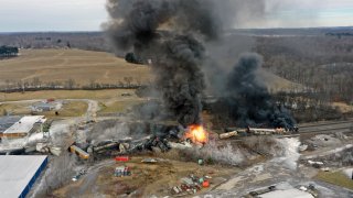 FILE – This photo taken with a drone shows portions of a Norfolk Southern freight train that derailed Friday night in East Palestine, Ohio are still on fire at mid-day Saturday, Feb. 4, 2023.