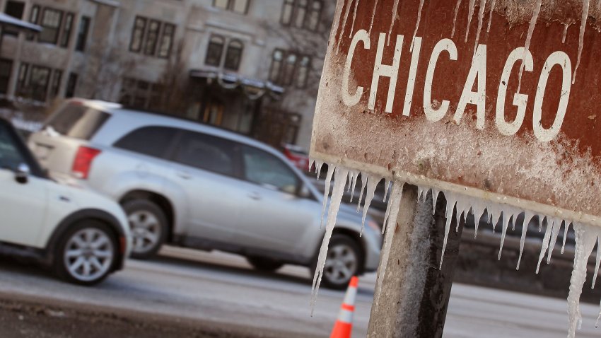 CHICAGO, IL – DECEMBER 13:  Ice clings to a sign along Lake Shore Drive after wind gusts upwards of 40 miles per hour blew waves onto the shore and temperatures in the low teens quickly turned the spray to ice December 13, 2010 in Chicago, Illinois. Snow, frigid temperatures, and high winds caused the cancelation of over 1,500 flights at the cities airports and wreaked havoc across the Midwest.  (Photo by Scott Olson/Getty Images)