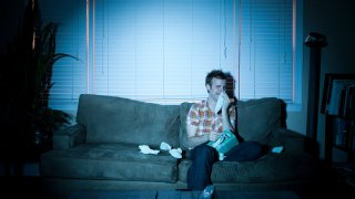 File photo of a young man crying alone in a room.