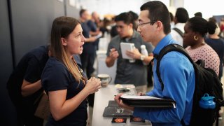 Amazon recruiters and other company volunteers speak to job seekers about opportunities at Amazon during a career fair held at Vertiport Chicago on September 17, 2019 in Chicago, Illinois.