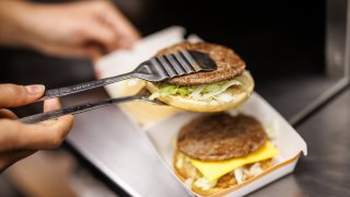 An employee stacks a Big Mac during preparation at a branch of the McDonald’s fast food chain