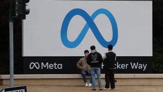 Visitors take photos in front of the Meta sign at its headquarters in Menlo Park, California, United States on December 29, 2022.