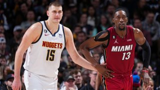 Nikola Jokic of the Denver Nuggets and Bam Adebayo of the Miami Heat /look on during the game on Dec. 30, 2022 at the Ball Arena in Denver, Colo.