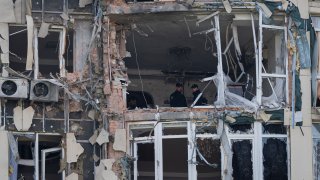 Police inspect an apartment building damaged by a drone, that was shot down during a Russian overnight strike, in Kyiv, Ukraine, Monday, May 8, 2023.