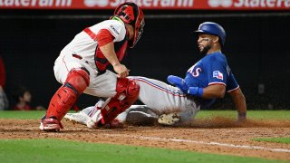 Los Angeles Angels catcher Matt Thaiss (21) tags Texas Rangers center fielder Leody Taveras (3) out at the plate in the eighth inning of an MLB baseball game played on May 5, 2023 at Angel Stadium in Anaheim, CA.