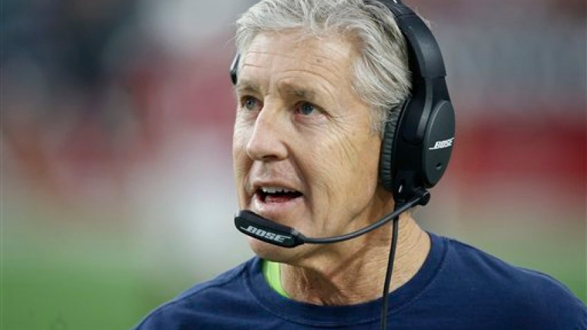 Seattle Seahawks head coach Pete Carroll makes a call during the first half of an NFL football game against the Arizona Cardinals, Sunday, Jan. 3, 2016, in Glendale, Ariz. (AP Photo/Ross D. Franklin)