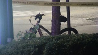 A red bicycle is seen parked next to a tree, with crime scene tape along the top of the handlebars. The bike was used in a South Loop assault in May 2023.