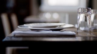 Profile of table setting from San Francisco restaurant, with plates, napkin, fork, and glass.